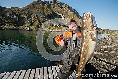 Happy fisherman showing thumb. The huge fish. The horizontal position Stock Photo