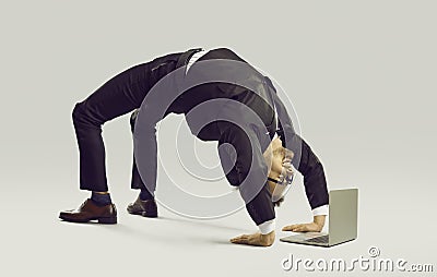 Happy flexible businessman in suit doing yoga while working on his laptop computer Stock Photo