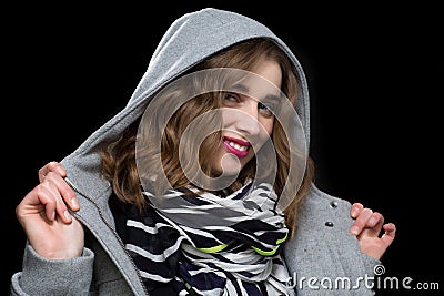 Happy flirtatious woman in a hooded jacket Stock Photo