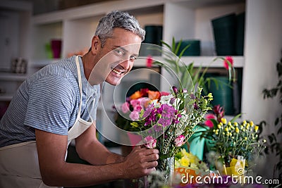 Happy florist preparing a flower bouquet Stock Photo