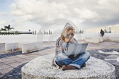 Happy and free digital nomad alternative woman working with technology everywhere in the world traveling a lot - travel lifestyle Stock Photo