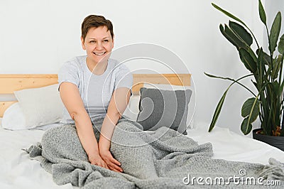 Happy fresh beautiful mature older woman awake after healthy sleep stretch wake up in cozy comfortable bed, smiling Stock Photo