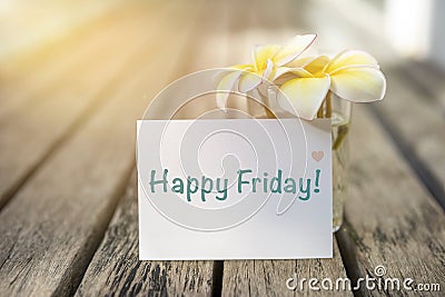 Happy Friday greeting card with Plumerial flower on wooden floor Stock Photo