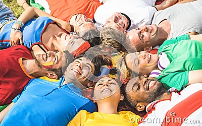 Happy friend group lying on meadow after world soccer event - Fr Stock Photo