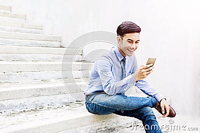 Happy and friendly young Businessman using or Working on Smart P Stock Photo