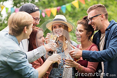 Happy friends clinking glasses at summer garden Stock Photo