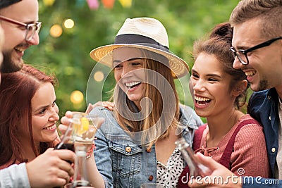 Happy friends clinking glasses at summer garden Stock Photo