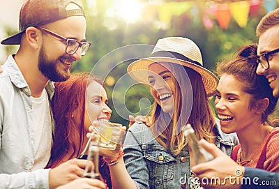 Happy friends clinking glasses at summer garden Stock Photo