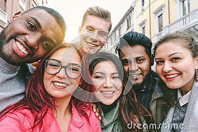 Happy friends from diverse cultures and races taking selfie with back lighting - Youth and friendship concept with young people Stock Photo