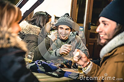 Happy friends drinking beer and eating chips by night Stock Photo