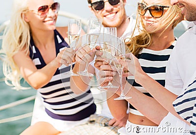 Happy friends with glasses of champagne on yacht Stock Photo