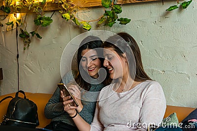 Happy friends group looking a mobile at brewery bar restaurant Stock Photo