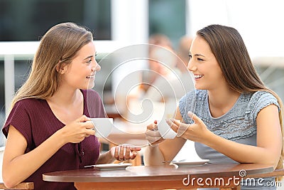 Happy friends having a conversation in a bar Stock Photo