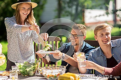 Happy friends having dinner at summer garden party Stock Photo