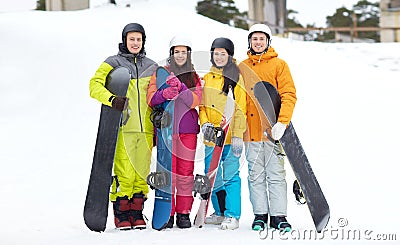 Happy friends in helmets with snowboards Stock Photo