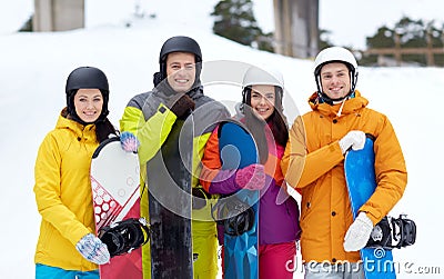 Happy friends in helmets with snowboards Stock Photo