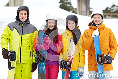 Happy friends in helmets with snowboards Stock Photo