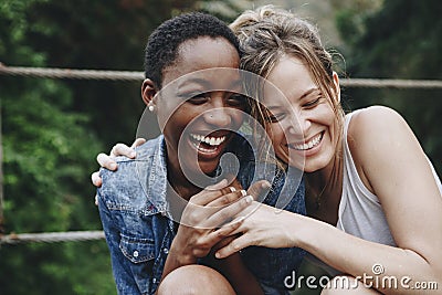 Happy friends holding each other Stock Photo