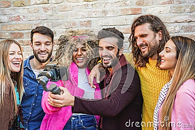 Happy friends making video feed with gimbal smartphone outdoor - Young people having fun with new technology trends - Youth Stock Photo