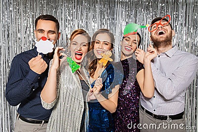 Happy friends posing with christmas party props Stock Photo