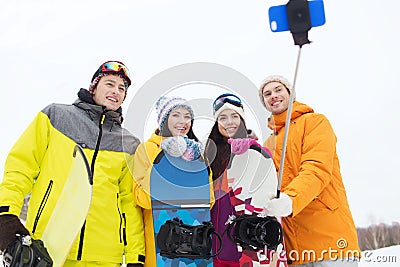 Happy friends with snowboards and smartphone Stock Photo