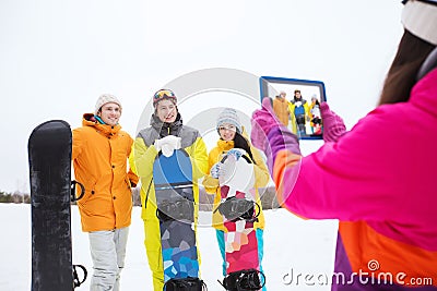 Happy friends with snowboards and tablet pc Stock Photo
