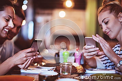 Happy friends take a food picture for instagram Stock Photo