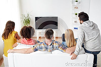 Happy friends watching tv at home Stock Photo