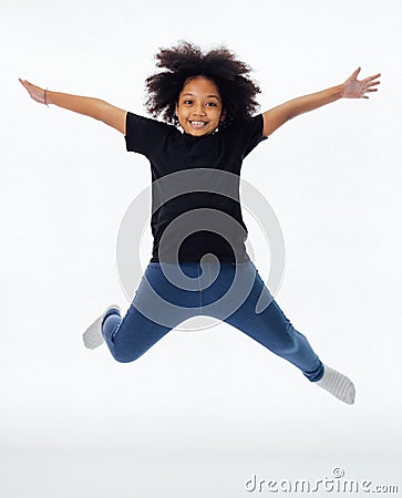 Happy and fun African American black kid jumping with hands raised isolated over white background. Stock Photo