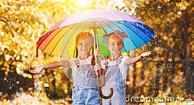 Happy funny sisters twins child girl with umbrella in autumn Stock Photo