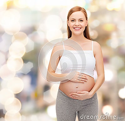 Happy future mother touching her belly Stock Photo