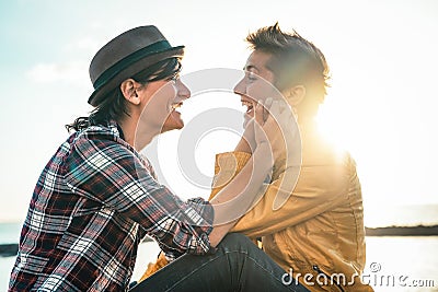 Happy gay couple dating next the beach at sunset - Young lesbian women having a tender romantic moment outdoor Stock Photo