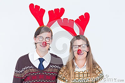 Happy geeky hipster couple with stag headband Stock Photo