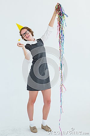 Happy geeky hipster holding confetti and horn Stock Photo