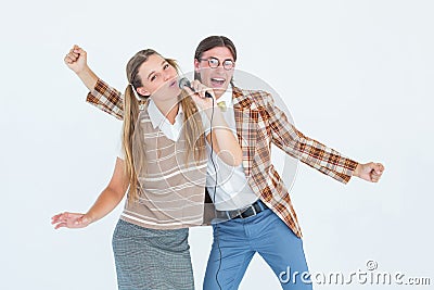 Happy geeky hipsters singing with microphone Stock Photo