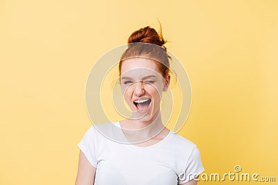 Happy ginger woman in t-shirt winks at the camera Stock Photo