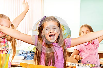 Happy Girl with arms apart laughs during lesson Stock Photo