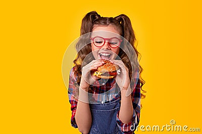 Happy girl biting delicious hamburger Stock Photo