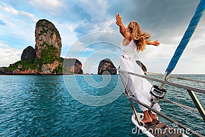 Happy girl on board of sailing yacht have a fun. Stock Photo