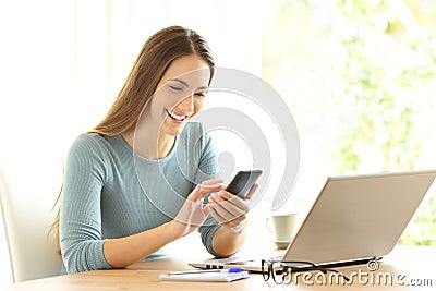 Happy girl checking on line content on a smart phone Stock Photo