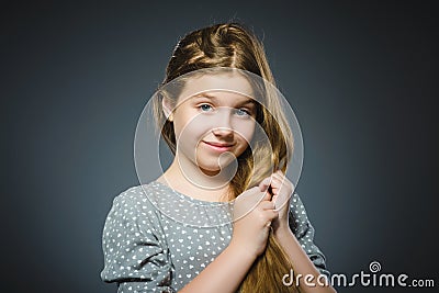 Happy girl. Closeup Portrait handsome child smiling on grey Stock Photo