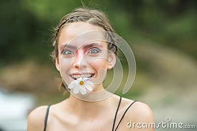 Happy girl with daisy flower in mouth Stock Photo