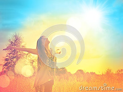 Happy girl enjoying the happiness on sunny meadow Stock Photo