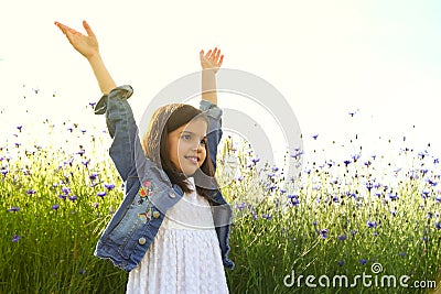 Happy girl on the field of beautiful blue flower of cornflower. Stock Photo