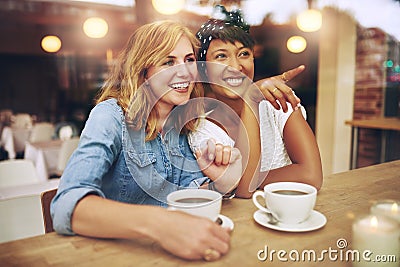 Happy girl friends pointing and smiling Stock Photo