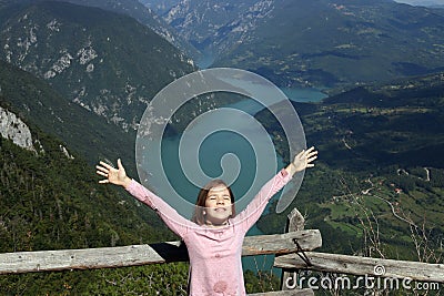 Girl with hands up on a fantastic viewpoint Banjska Stena Tara mountain Serbia Stock Photo
