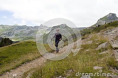 Happy girl hiking the mountains in Pyrenees Stock Photo