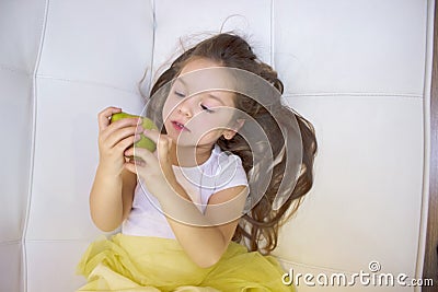 Happy girl holding and eating yellow sweet pear Stock Photo