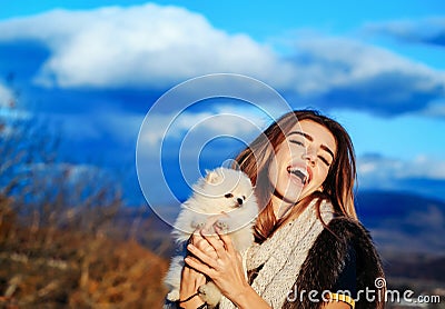 Happy girl holds cute dog Stock Photo