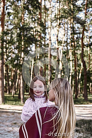 Happy, girl huggs her beautiful mother near forest. Close-up Stock Photo